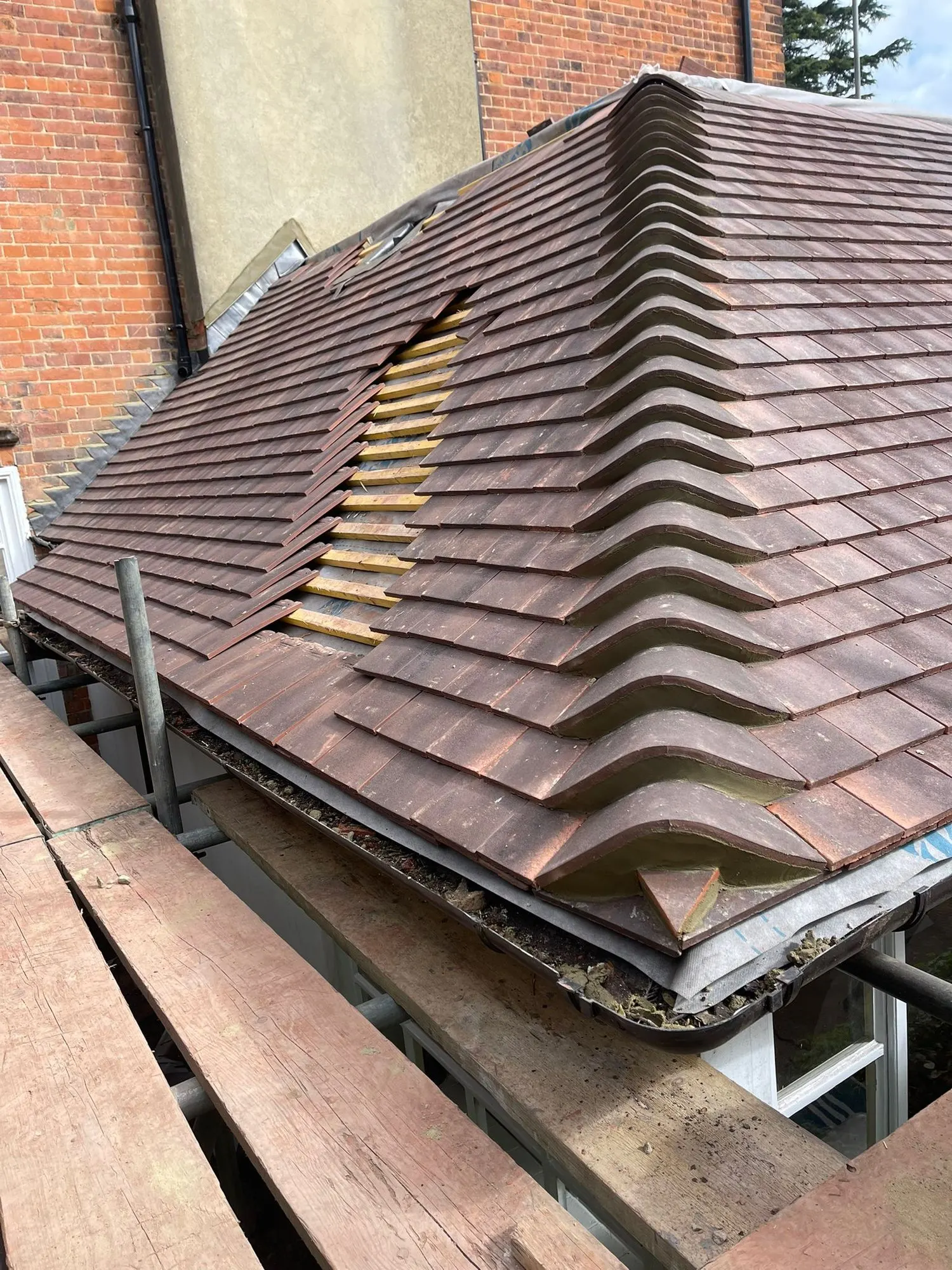 Clay tiled hip with ridge tiles