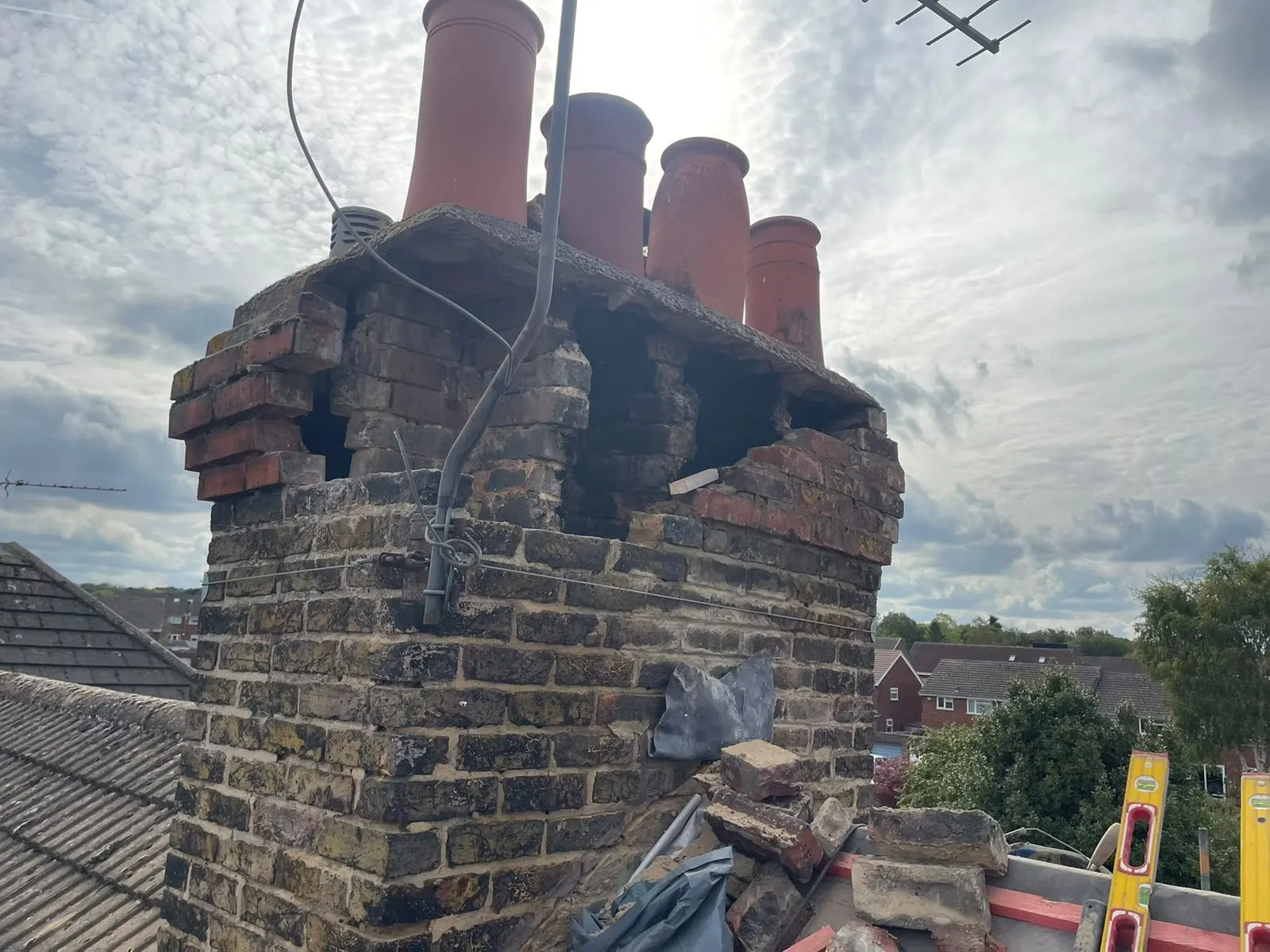 Crumbling chimney stack with damaged brickwork
