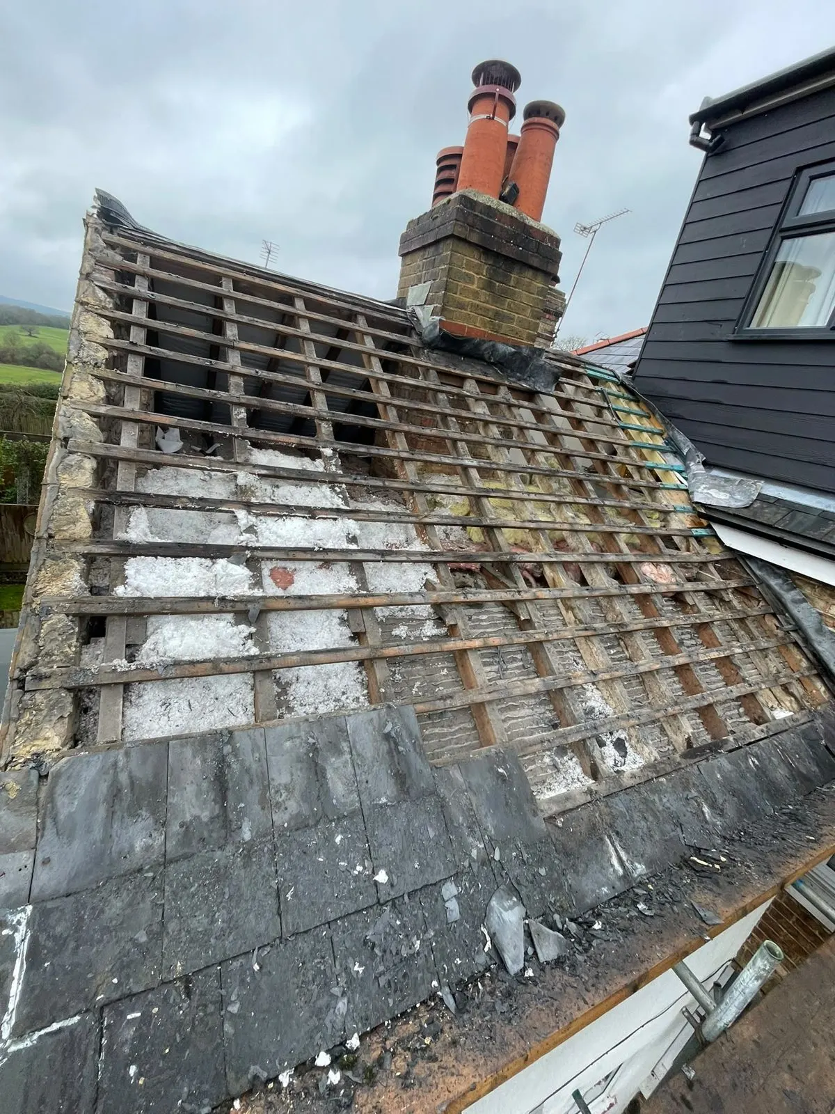 Roof stripped back showing old battens and insulation