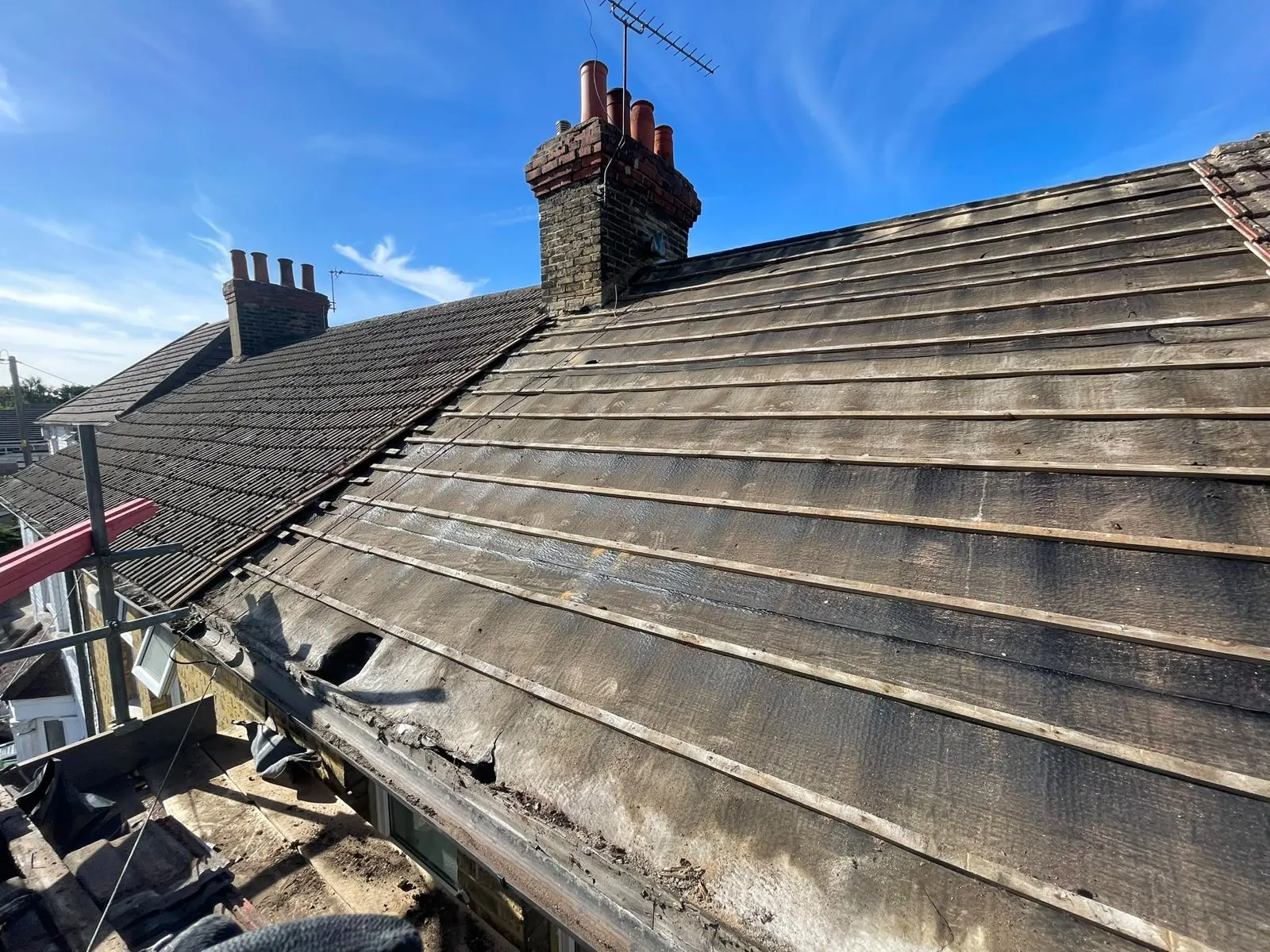 Worn tiled roof with stained, perished tiles