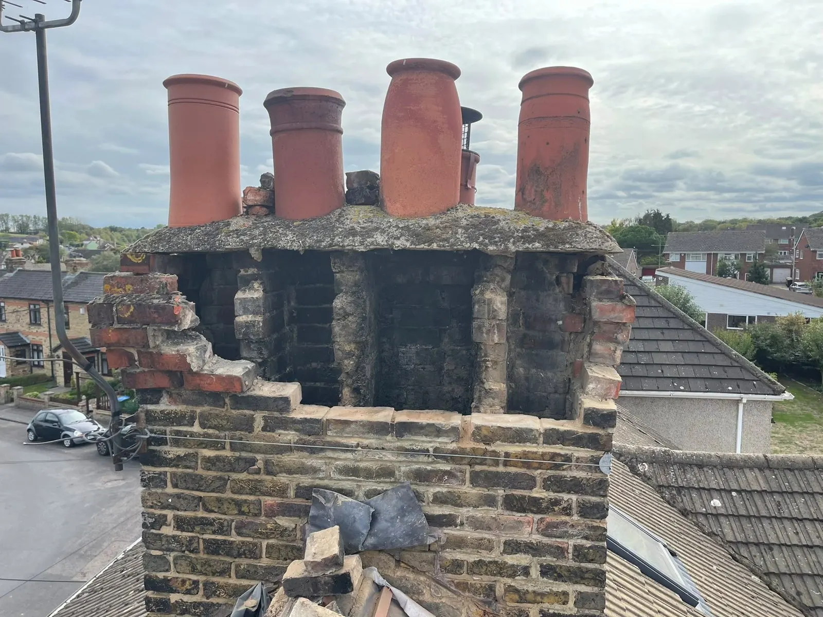 Crumbling chimney stack with damaged brickwork