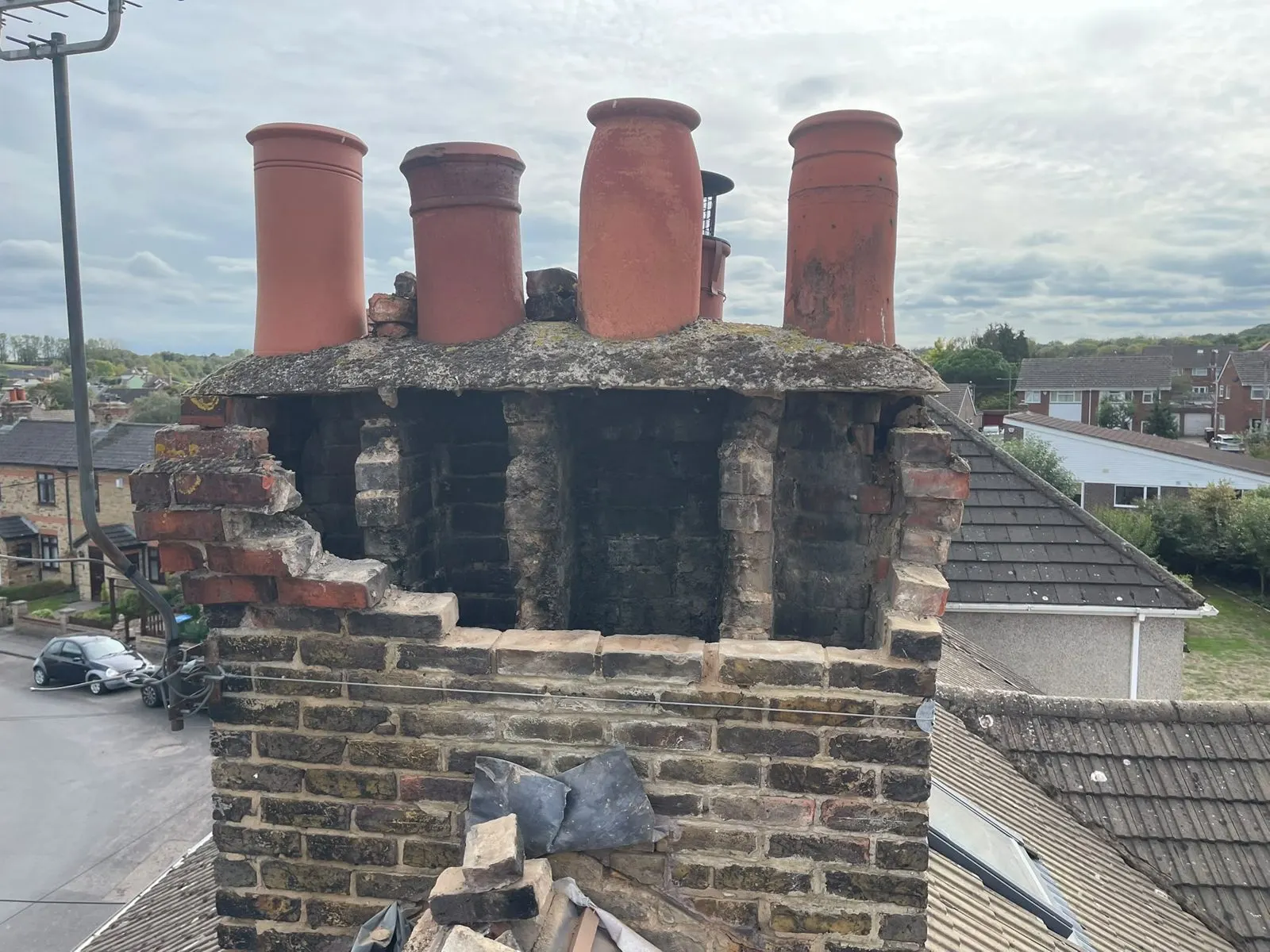 Crumbling chimney stack with damaged brickwork