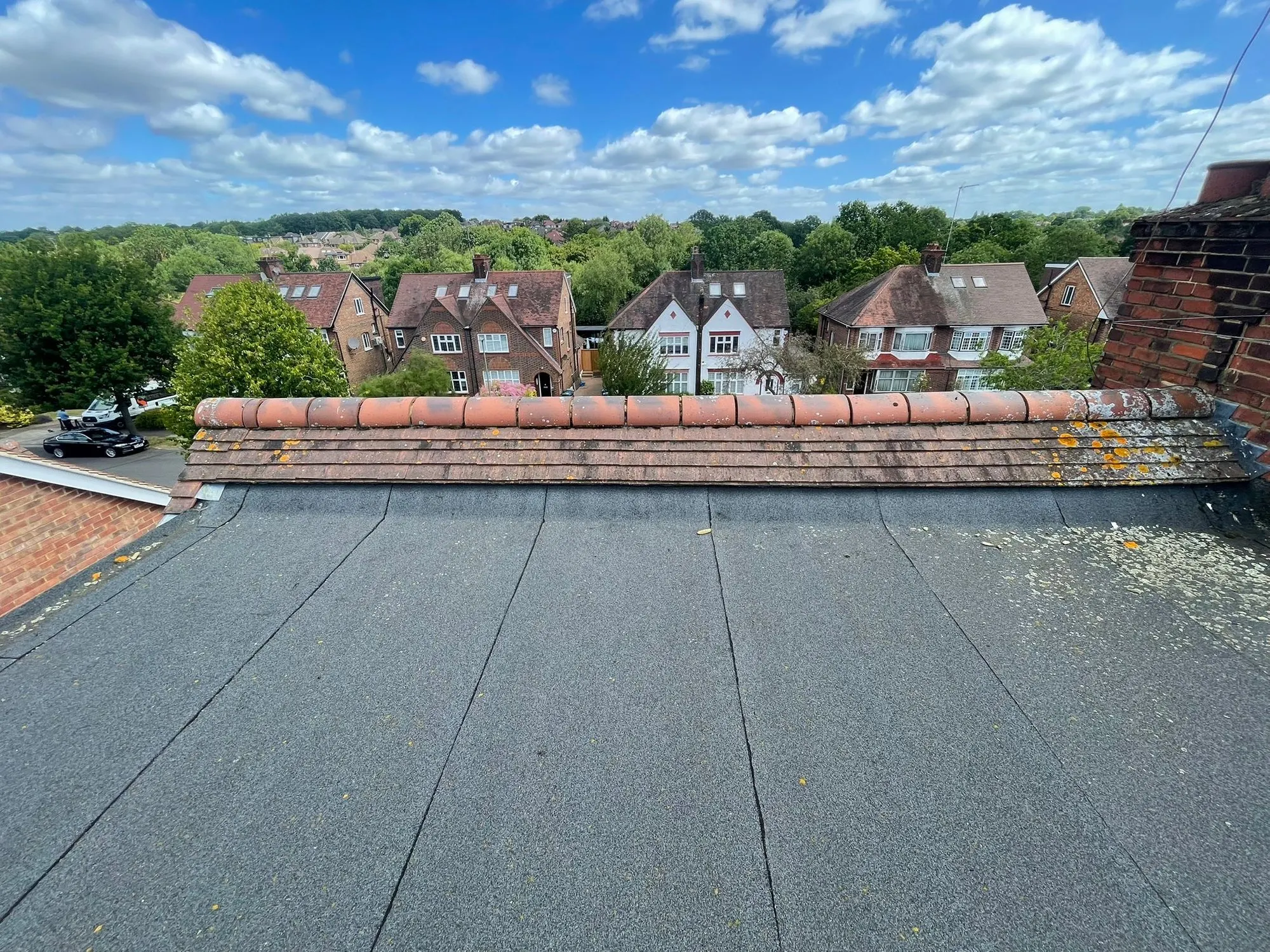 Flat roof with red clay ridge capping