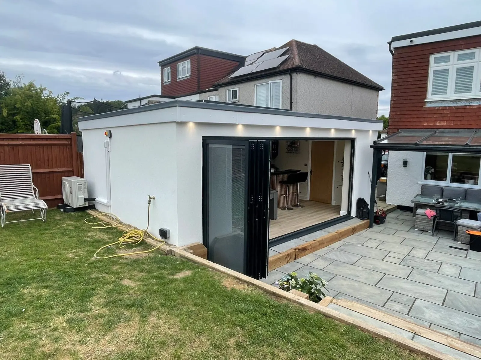 Garden room with bi-fold doors and a flat roof, G Scott Roofing, roofers and builders covering Sidcup