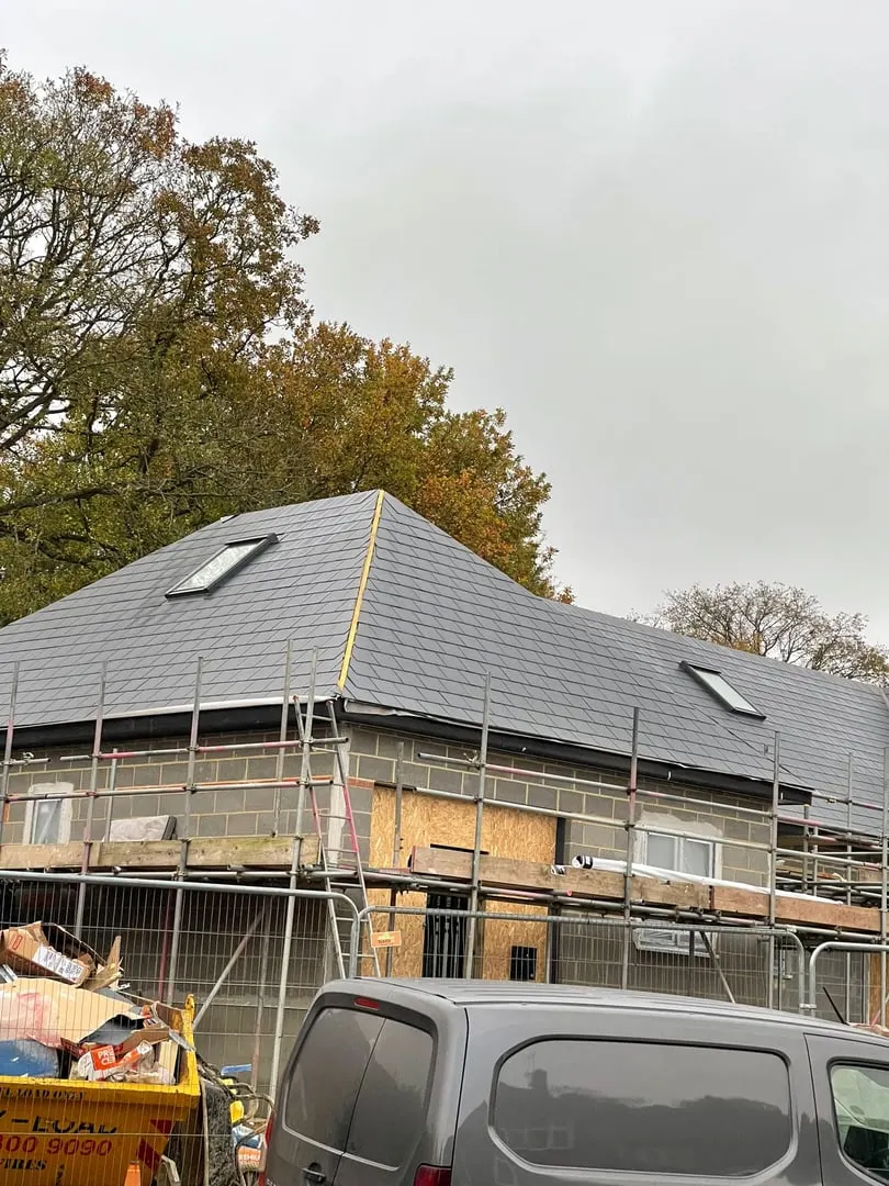 House with scaffolding and a new slate roof