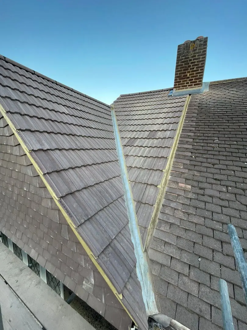 Tiled roof with lead flashing and a chimney