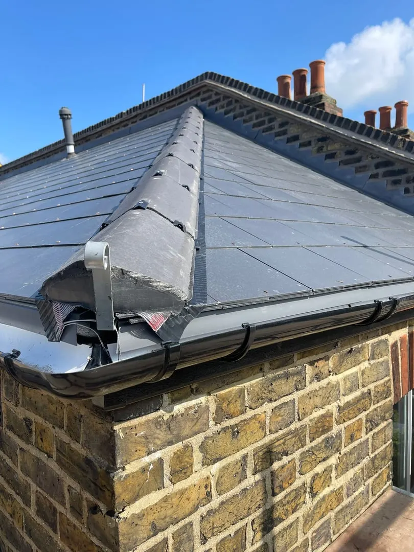 Slate roof hip with lead flashing and guttering
