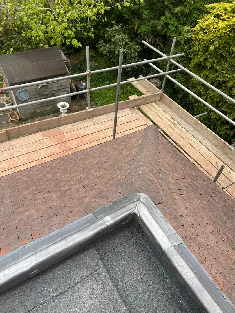 Flat roof edge with lead trim and scaffold