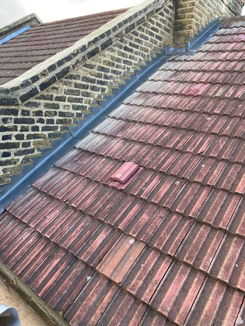 Clay tiled roof beside a brick wall