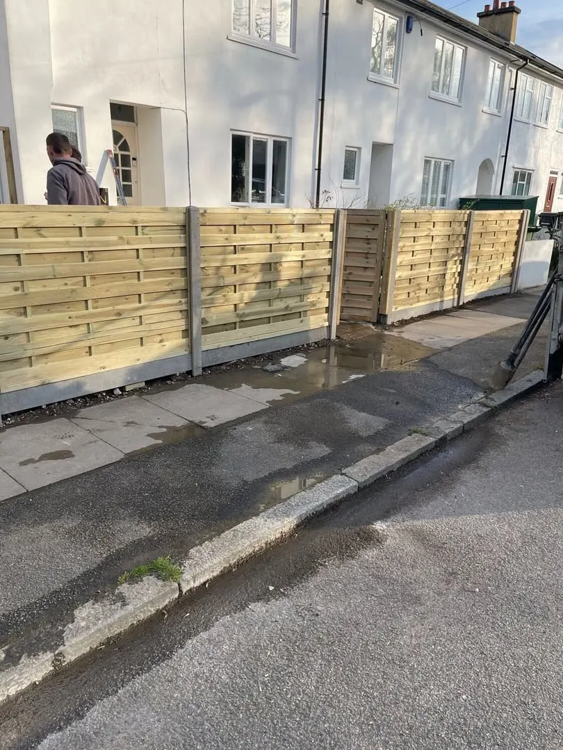 New timber fence and rendered wall