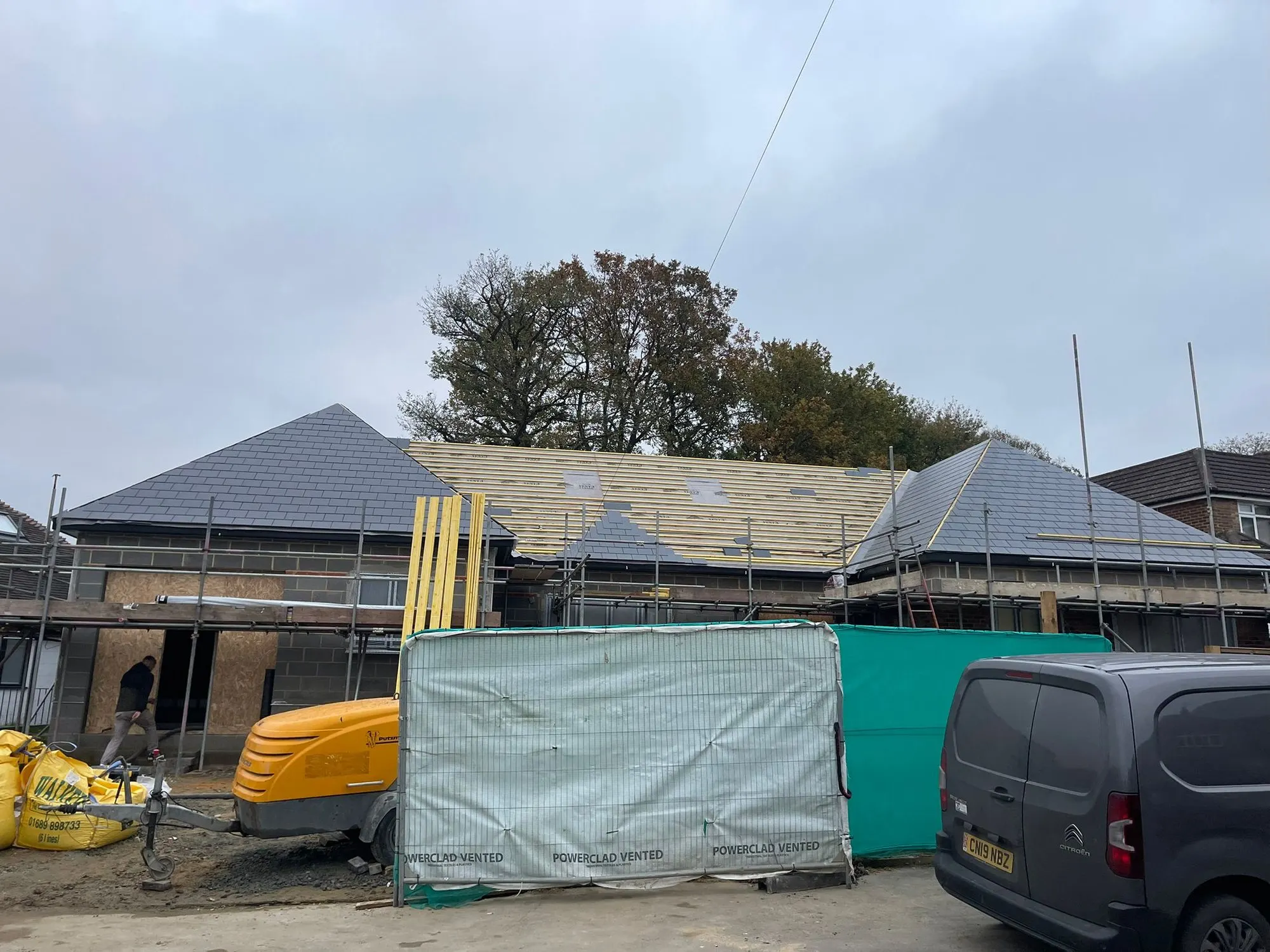 New roof under construction behind scaffold
