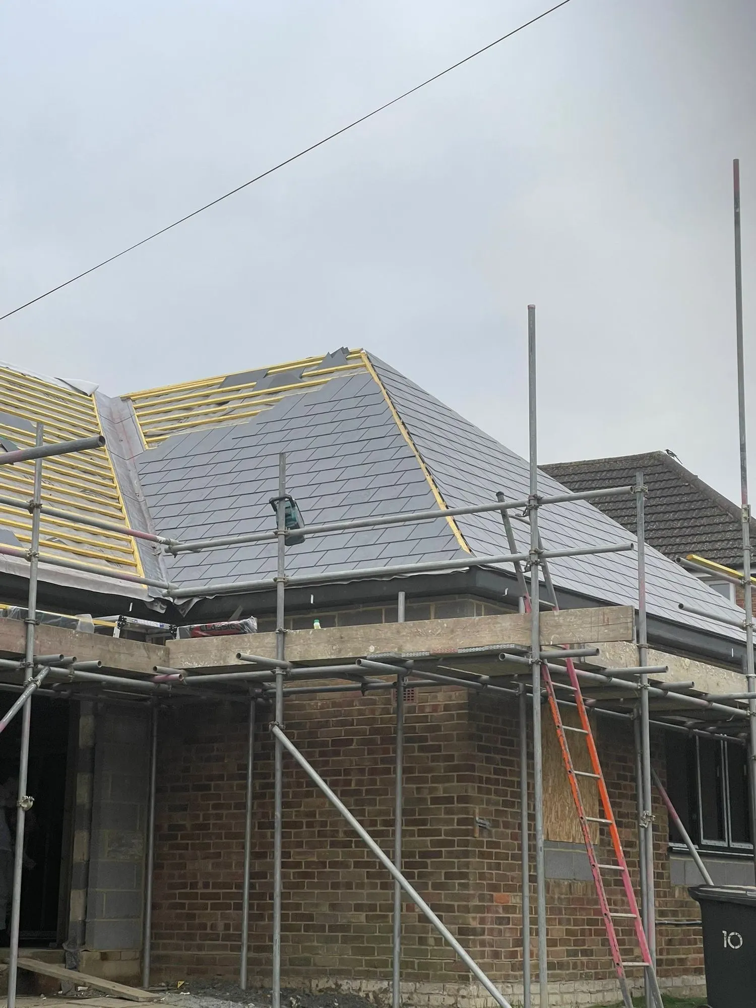 New slate roof on a scaffolded extension