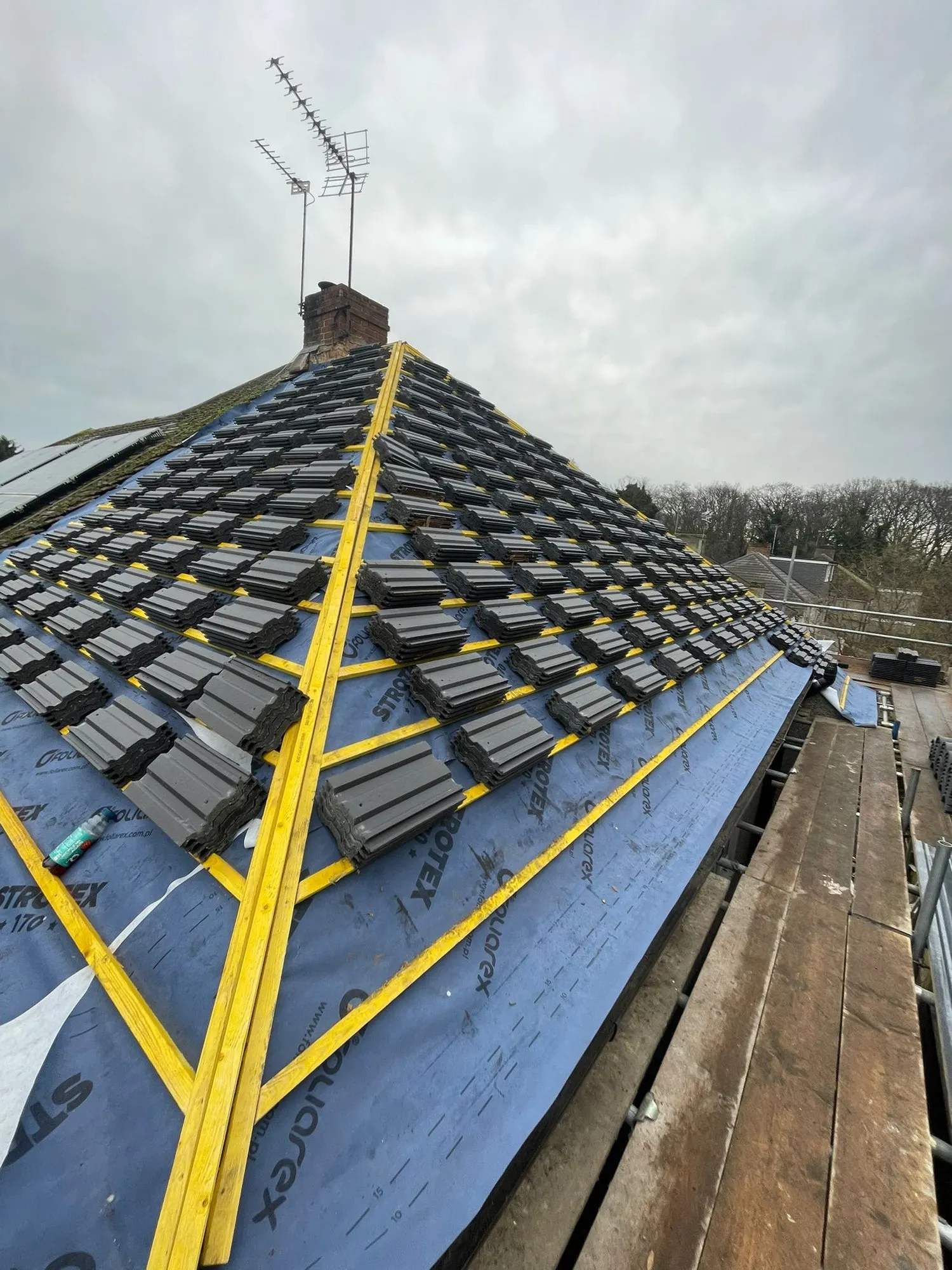 New tiles being laid over membrane and battens