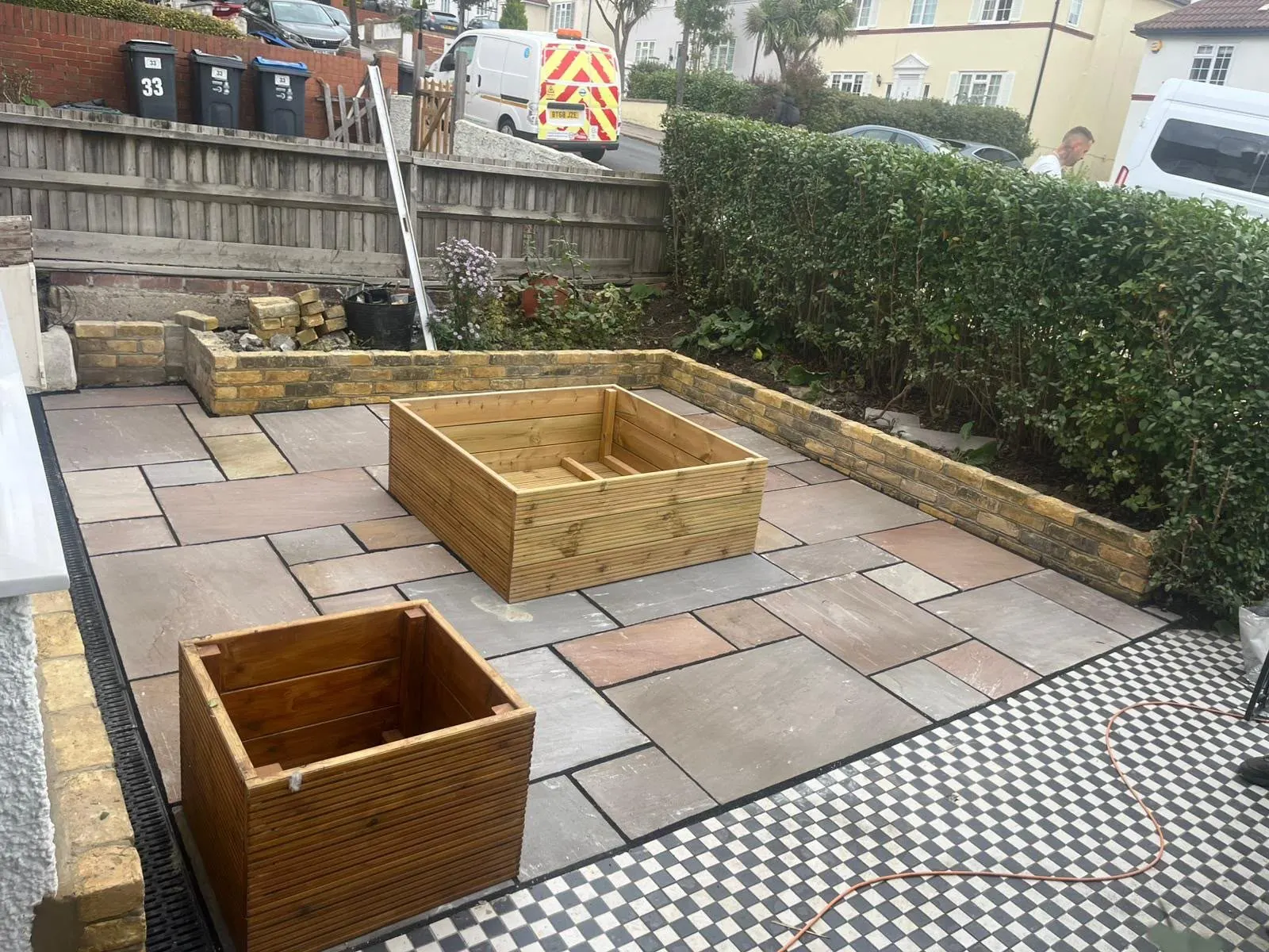 Paved patio with timber raised beds