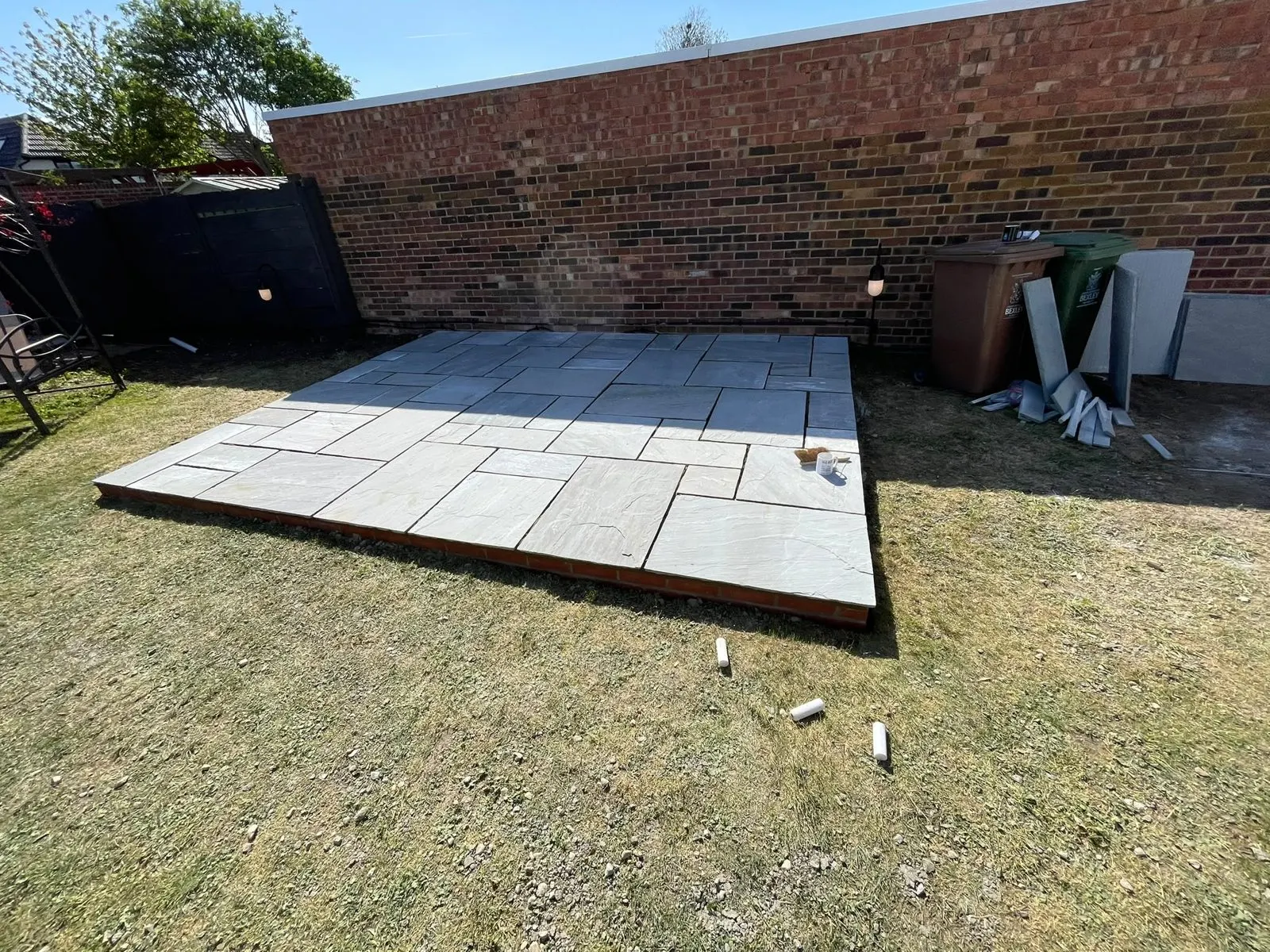 Paving being laid in a garden, G Scott Roofing, roofers and builders covering Chatham
