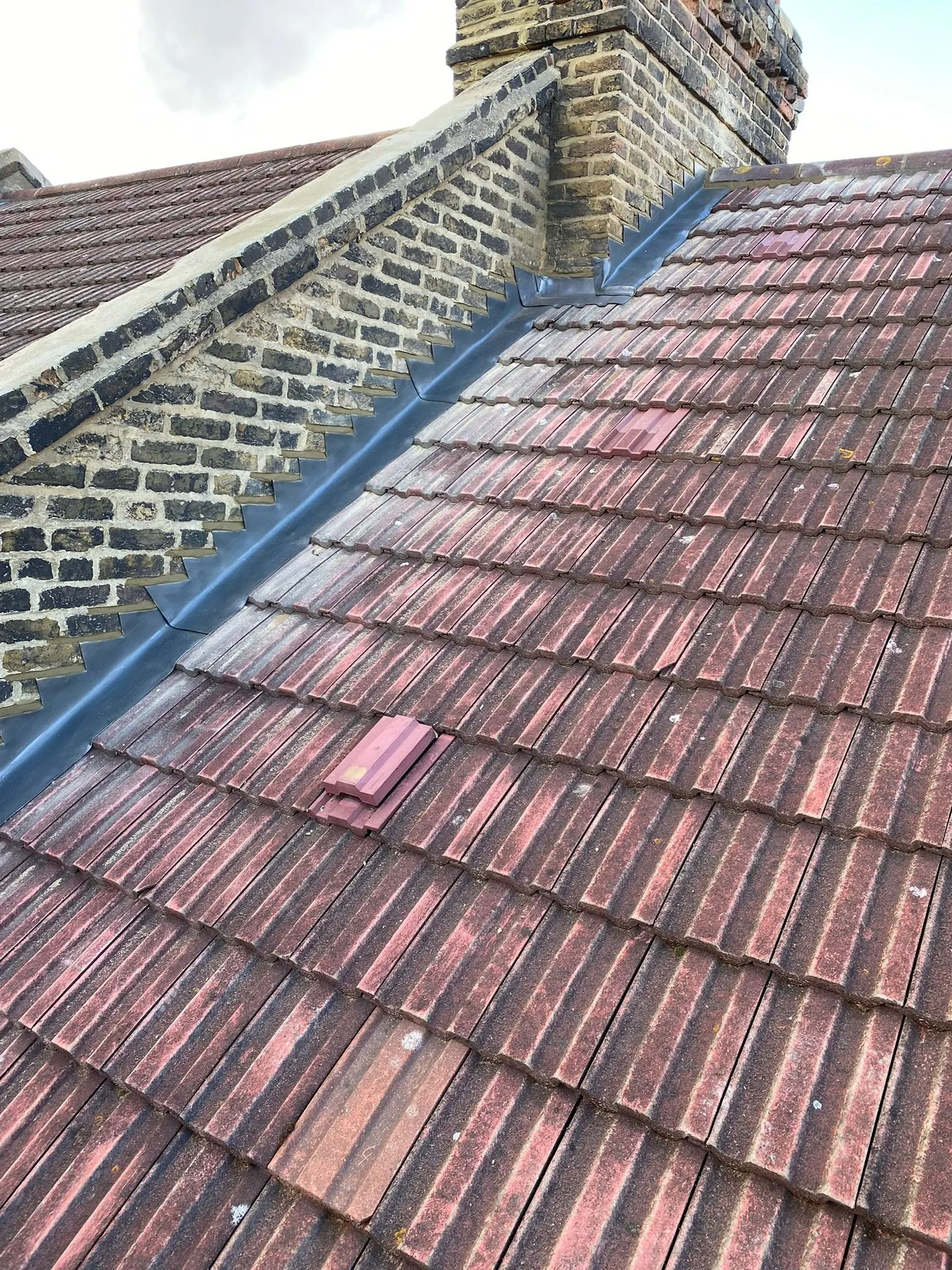 Red clay tiles with lead flashing