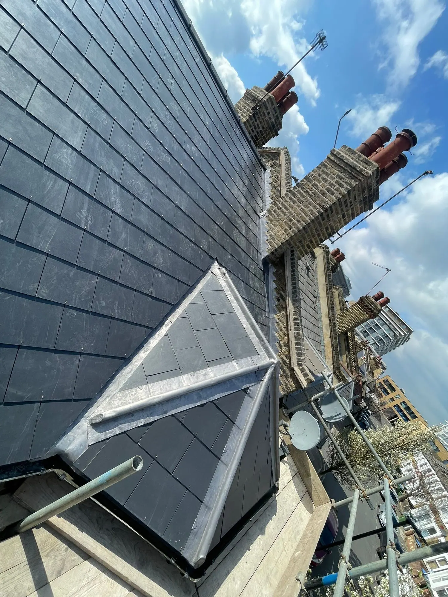 Slate roof with a rooflight and chimney