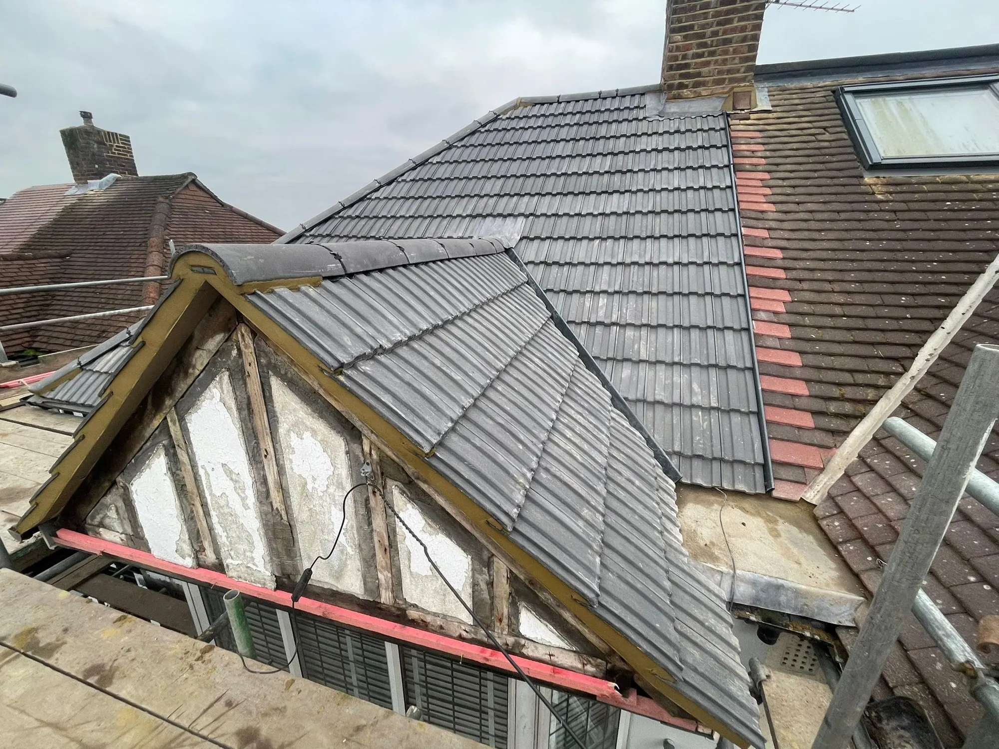 Tiled hip roof with a dormer and scaffold
