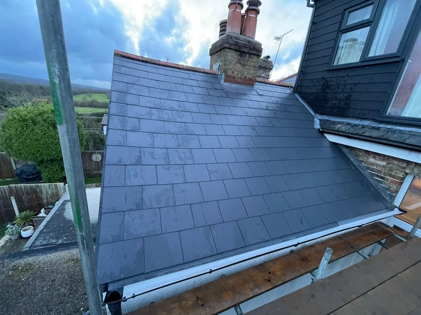 Slate roof with a chimney and dormer