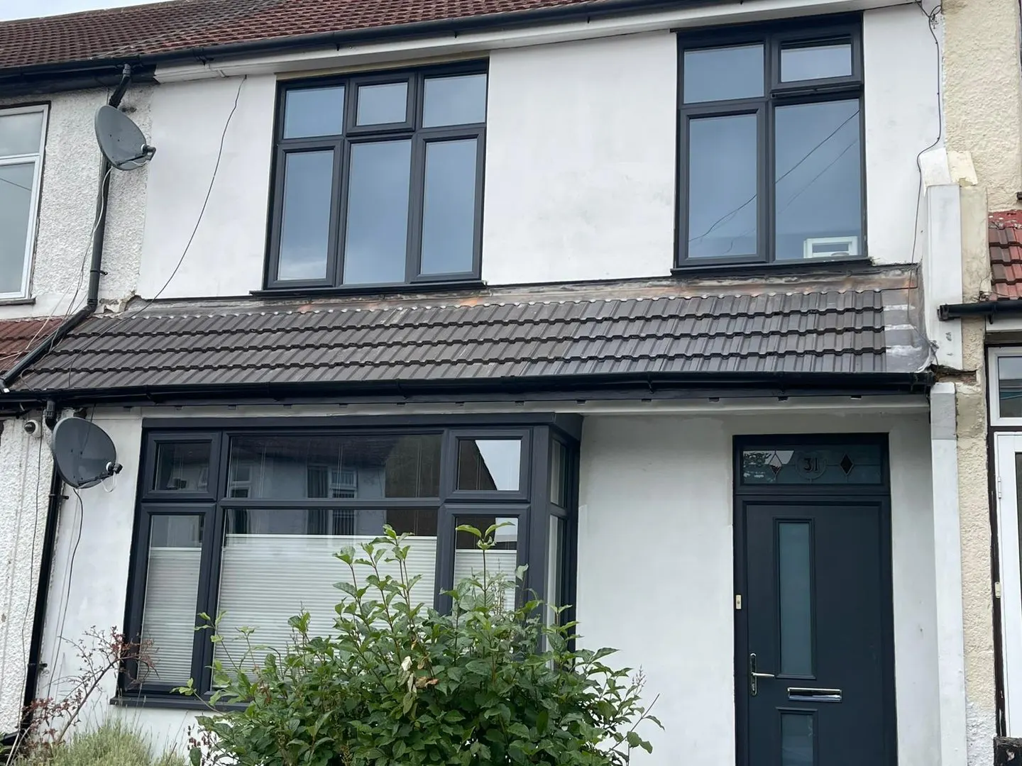 Rendered house front with new windows and door